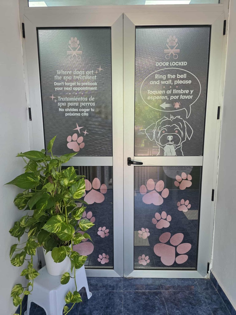 Front entrance doors with paw-print decals at Jodie's Groom Room dog grooming salon